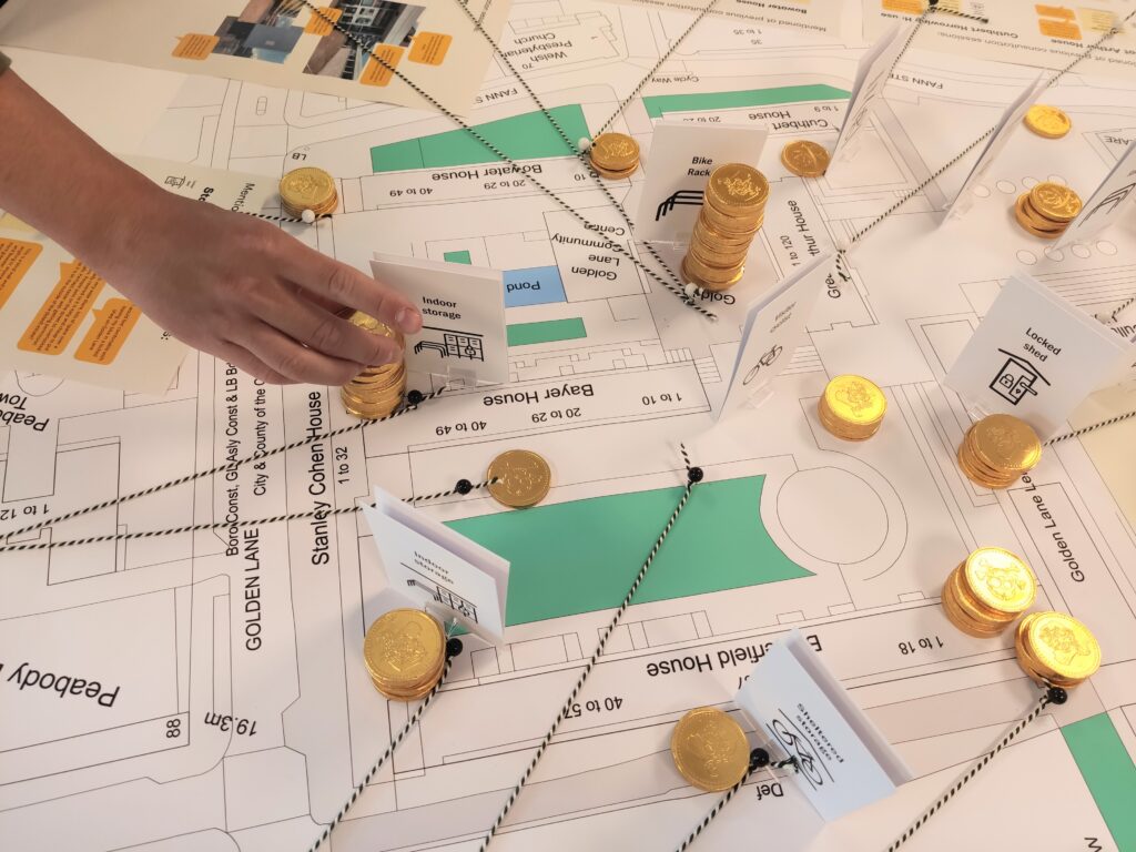 Close up of the map of the Golden Lane Estate with cards and coins to show the input of residents