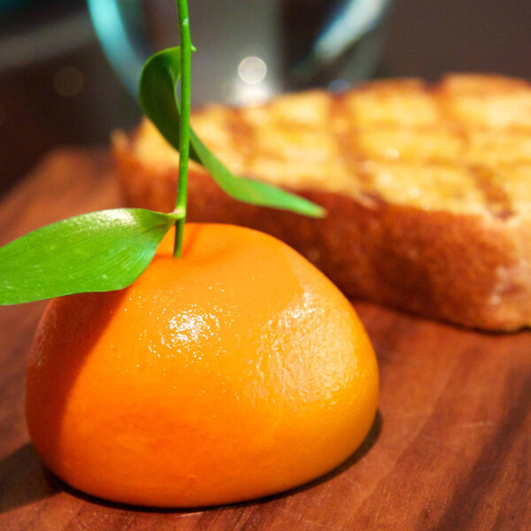 Orange and toast on wooden surface