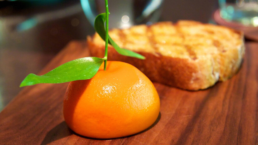 Orange and toast on wooden surface
