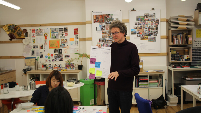 Trainer showing paper to students in class