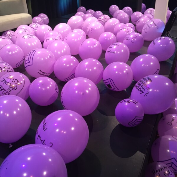 purple balloons with questions written on them