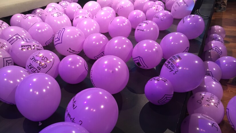 purple balloons with questions written on them